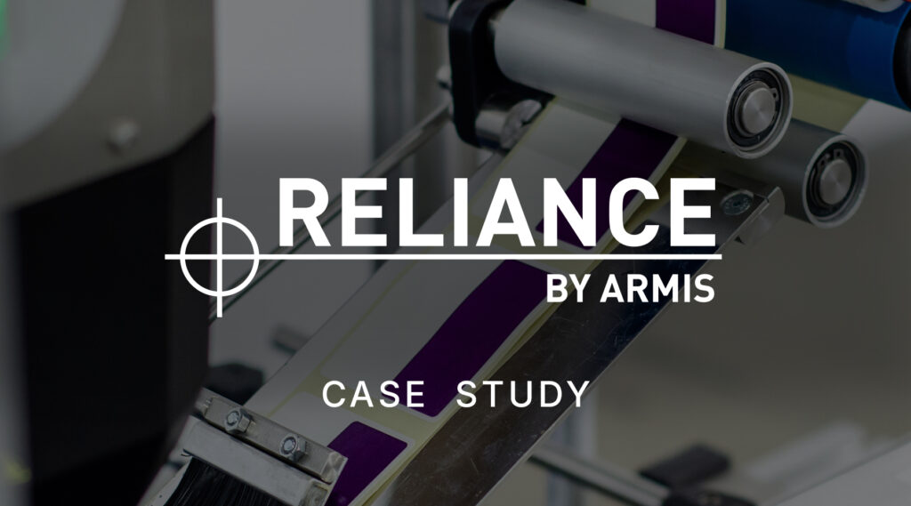 Close-up of industrial machinery with Reliance by Armis Case Study text overlay, rollers and material strips visible in background.