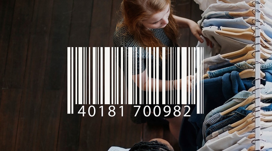 Woman browsing clothing rack from above, large barcode and numbers 40181 700982 overlaid on scene, shopping concept.