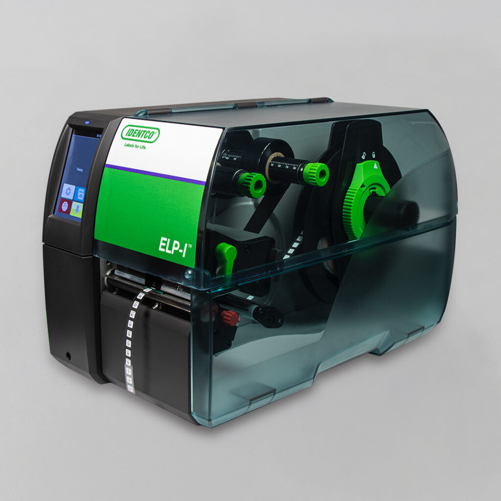 Compact industrial label printer with transparent cover, green and black components, control screen, and printed labels emerging front.