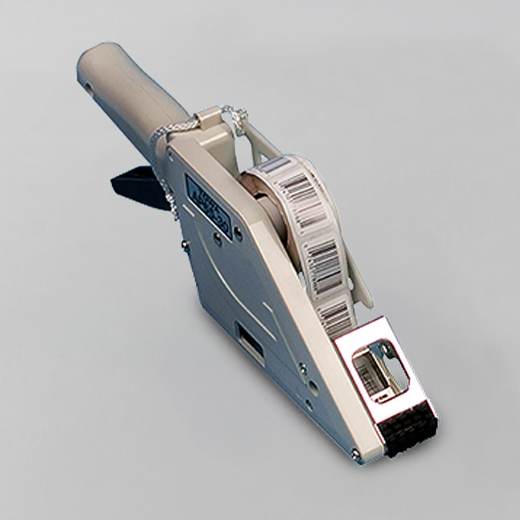 Handheld label applicator with trigger handle, metal dispenser, and white label roll, displayed on a plain light background.