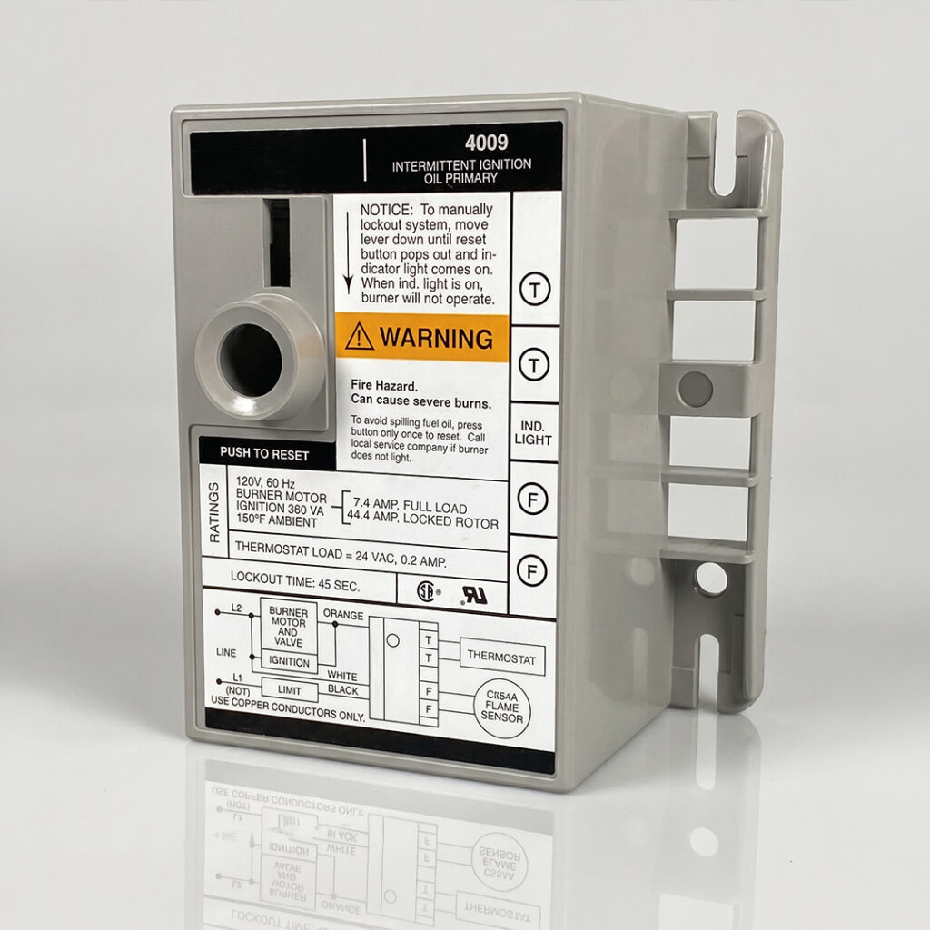 Gray electronic ignition control box with caution labels, dial, reset button, wiring diagram, and terminals for oil burner systems.