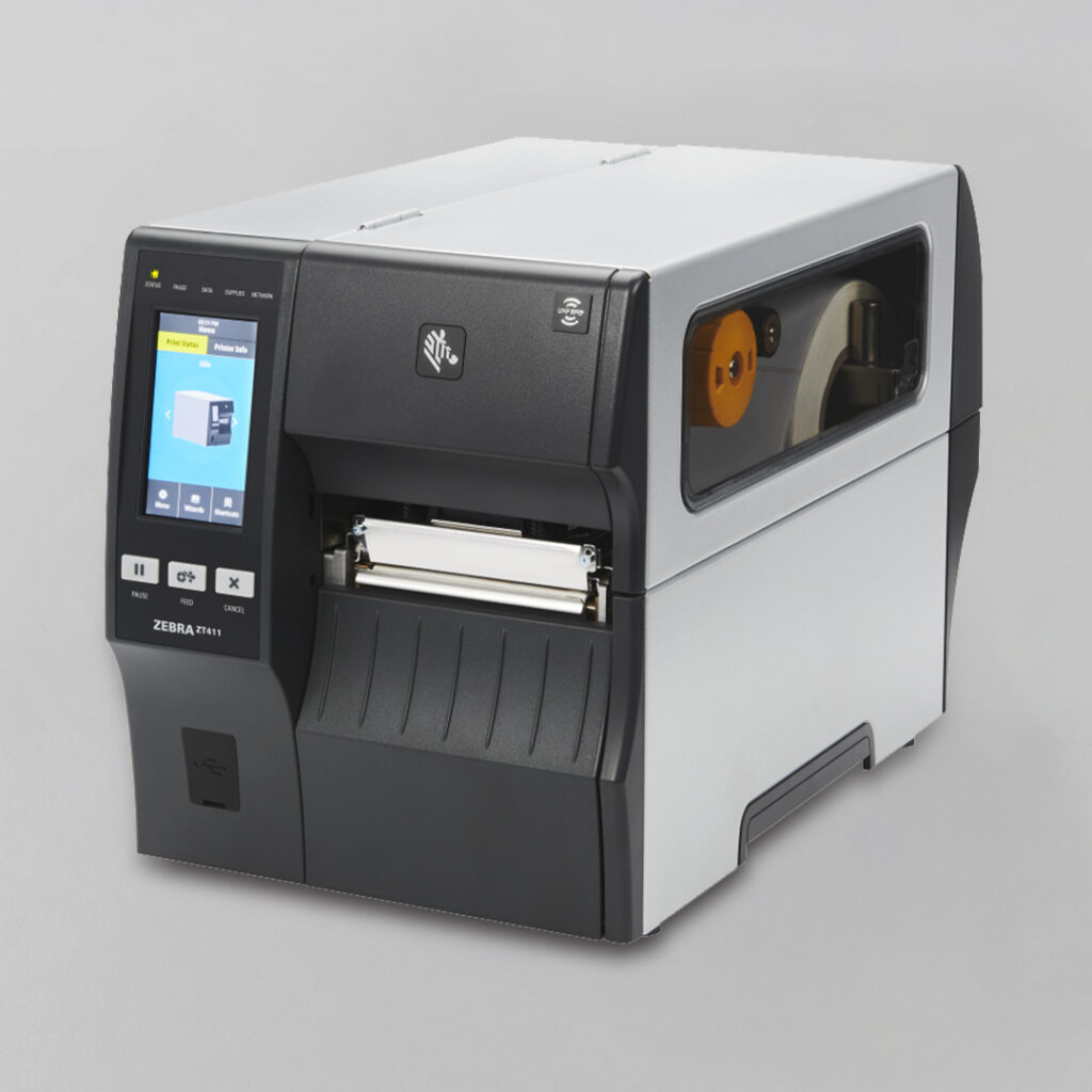 Zebra ZT411 industrial label printer angled on a light gray background, touchscreen display and side panel showing internal label roll.