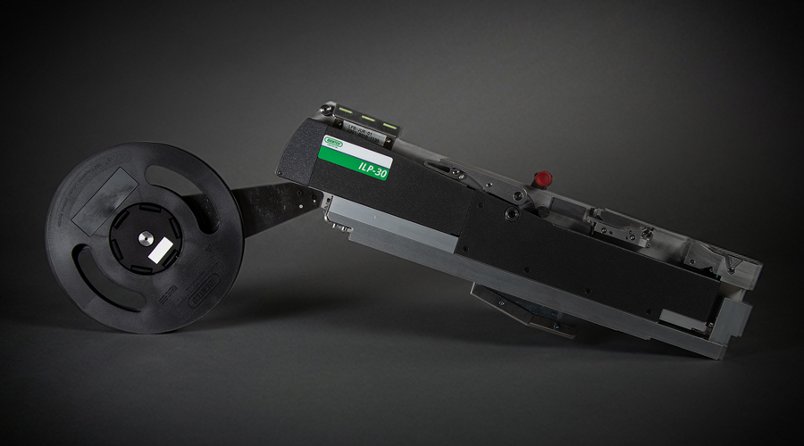 Black and metallic industrial machine part with left-side reel, labeled JLP-30, against dark background.