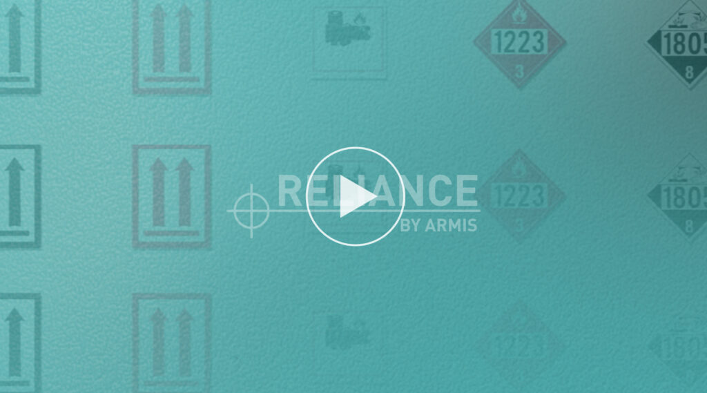 Teal background with faded hazardous materials labels, white play button centered, and faint RELIANCE BY ARMIS text behind button.