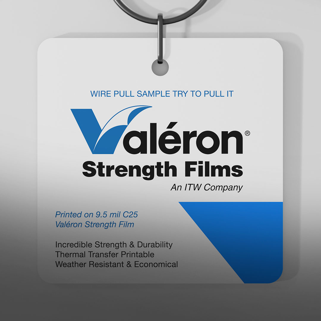 Sample tag with metal ring shows Valéron Strength Films blue logo, highlights strength, durability, printability, weather resistance.