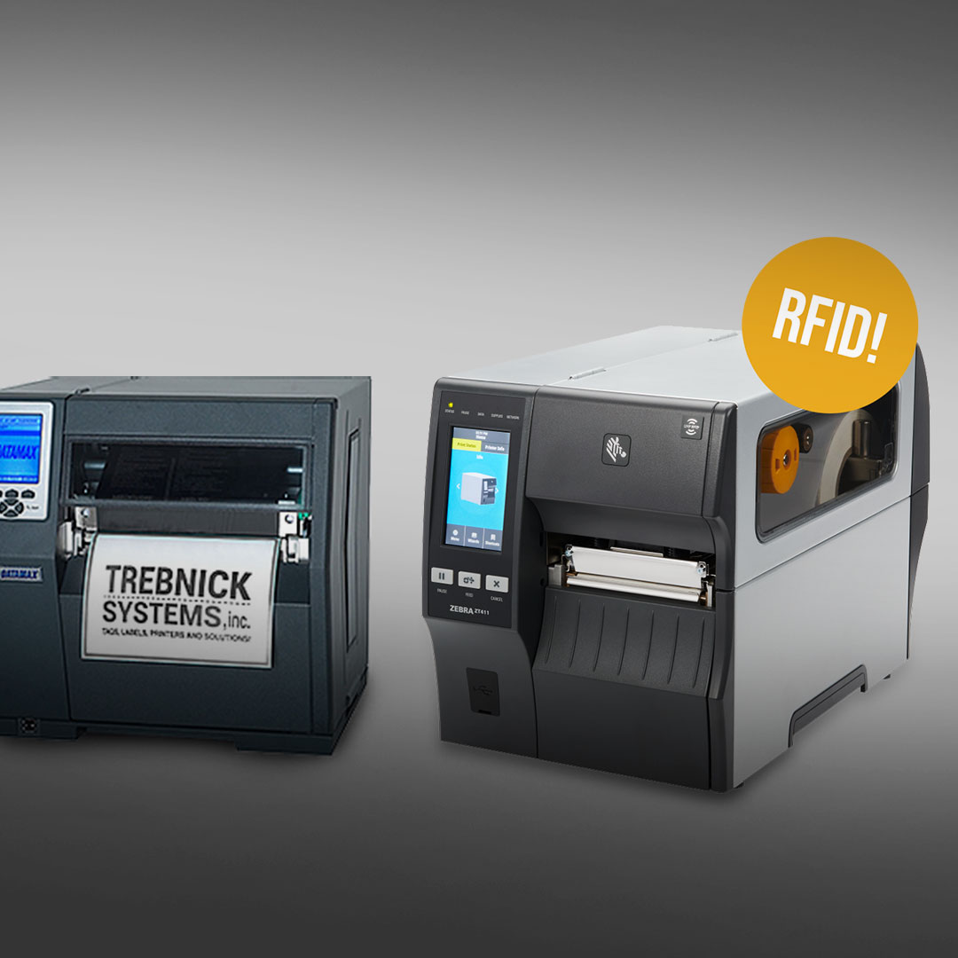 Two industrial label printers side by side on gray background, left shows TREBNICK SYSTEMS inc label, right has RFID sticker above.