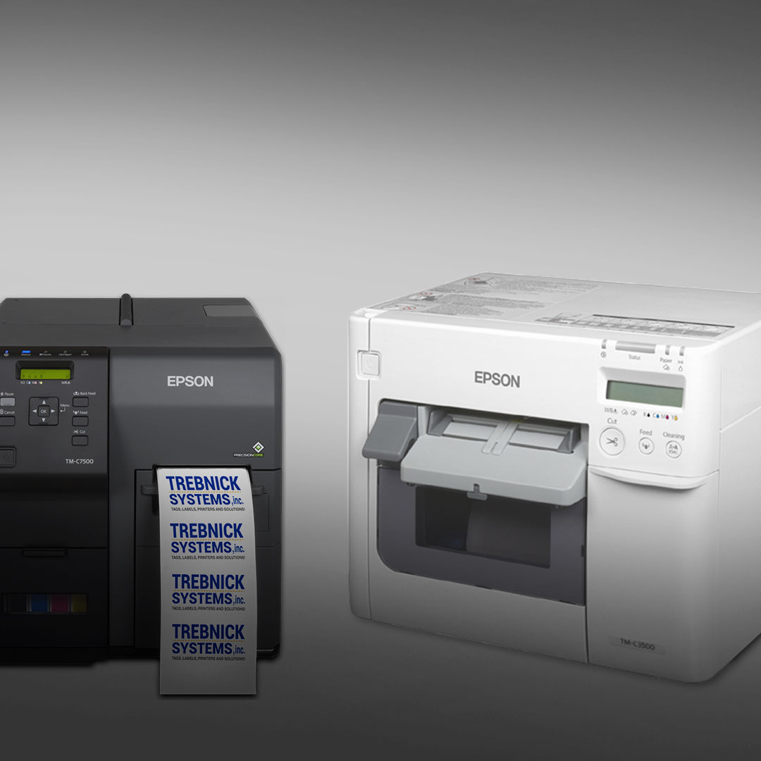 Black Epson label printer prints Trebnick Systems labels beside a white idle Epson printer on a gradient gray background.