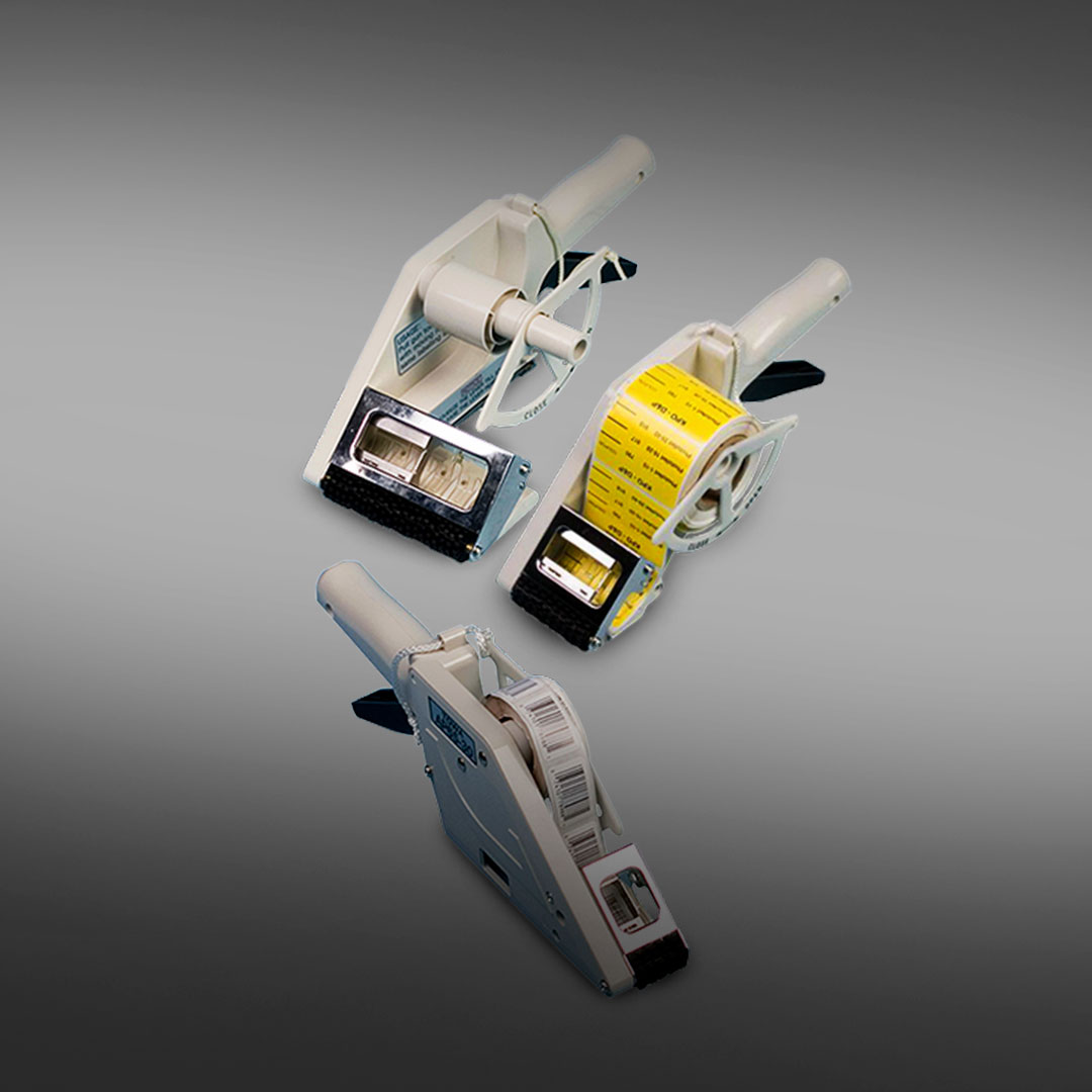 Three handheld label applicators on a gray background, one with yellow labels, others empty or with white labels, shown from different angles.