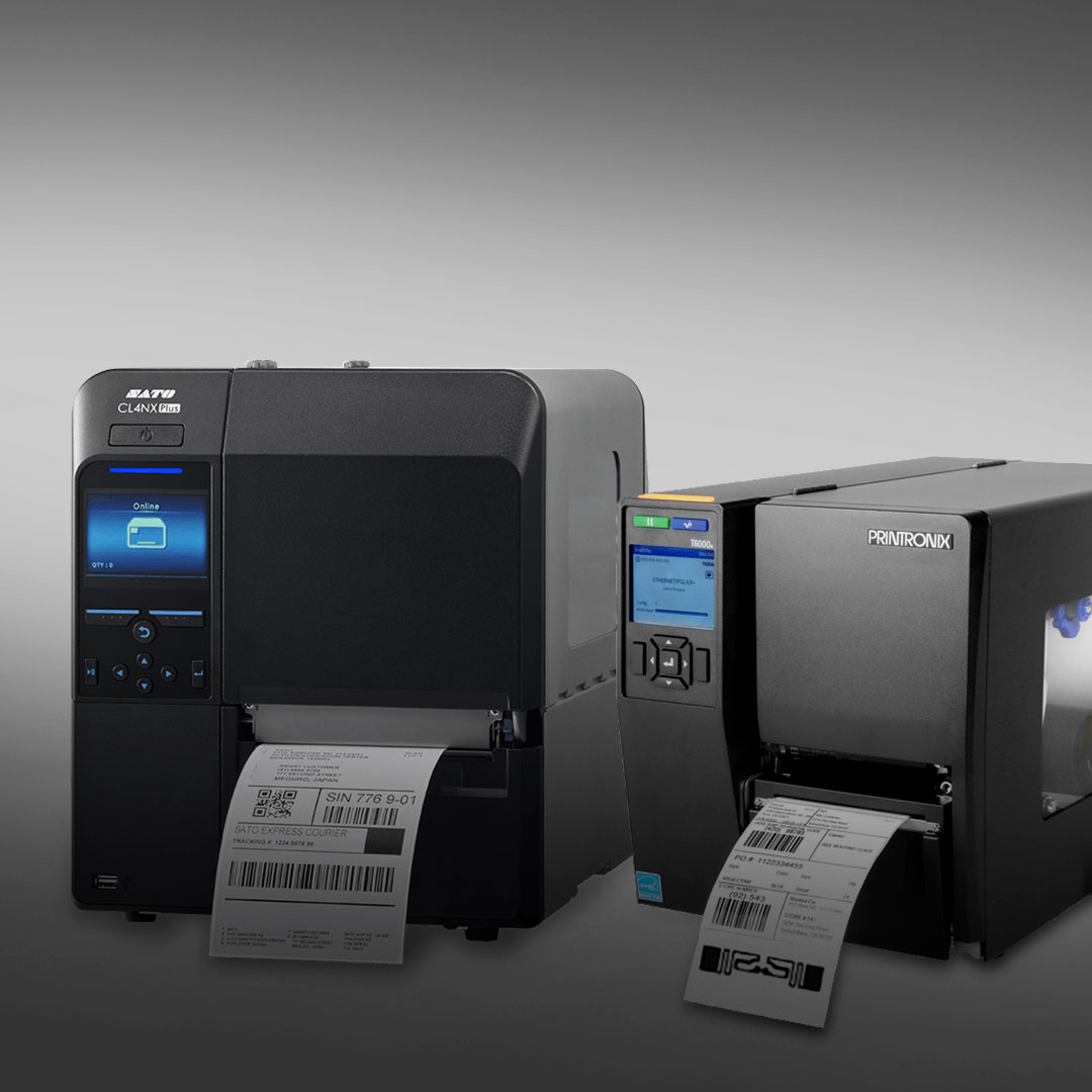 Industrial label printers side by side printing barcode labels, each with a front digital screen and buttons on a gray background.