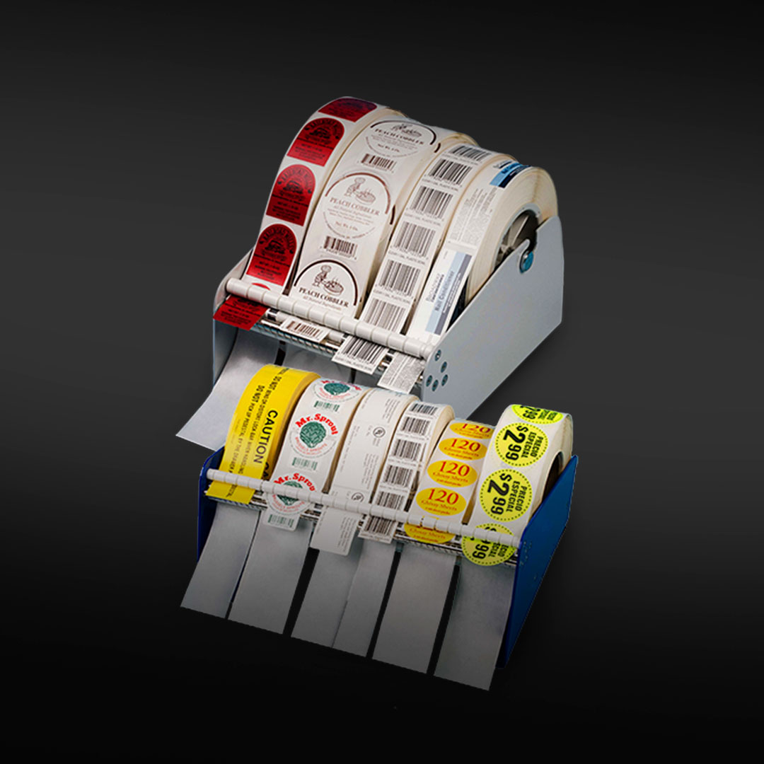 Metal dispensers display assorted colorful adhesive label rolls on a dark gradient background, featuring red, white, green, yellow, black.