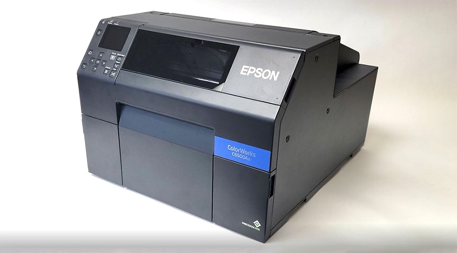 Epson ColorWorks C6500A black label printer on white surface with digital display and control buttons on upper left side.