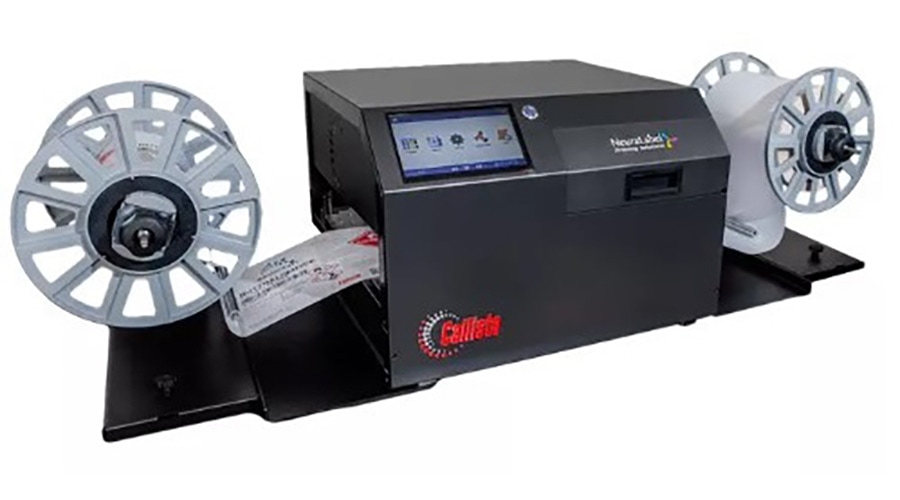 Colordyne black digital label printer with touchscreen, flanked by two large spools feeding a roll of labels through the machine.