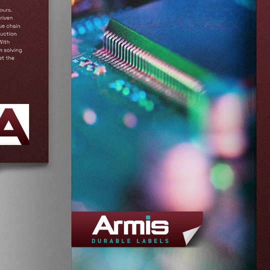 Blurred close-up of a computer chip and circuit board with an Armis DURABLE LABELS tag in the bottom right on a dark background.