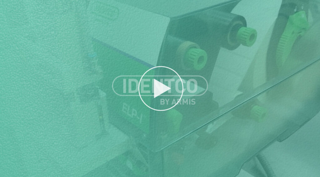 Green-tinted lab equipment with knobs and tubes, overlaid by IDENTOO BY AMMIS text and a central play button icon.