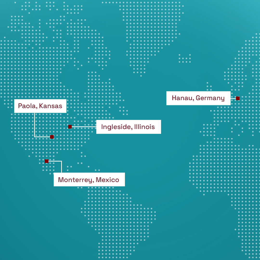 Dotted world map with red squares marking Paola, Ingleside, Monterrey, and Hanau, labeled and connected by lines.